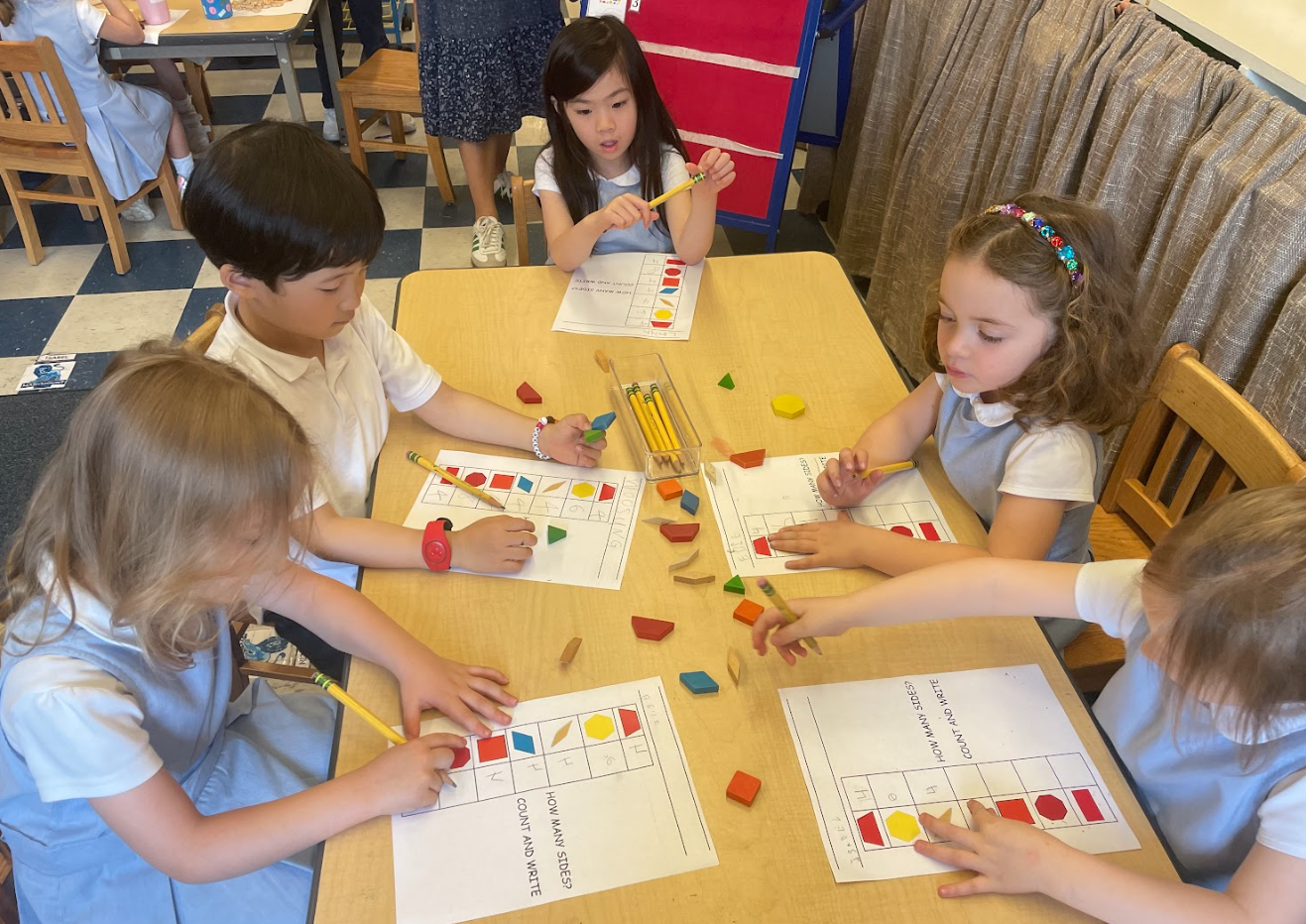 PreK students using shape building blocks