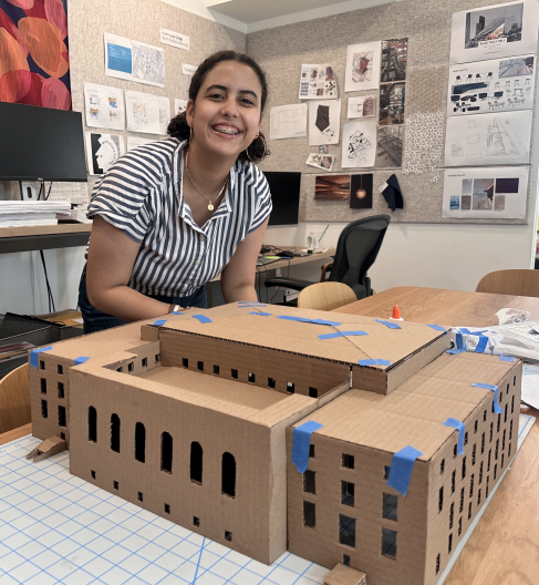 upper school student posing with a model TARDIS