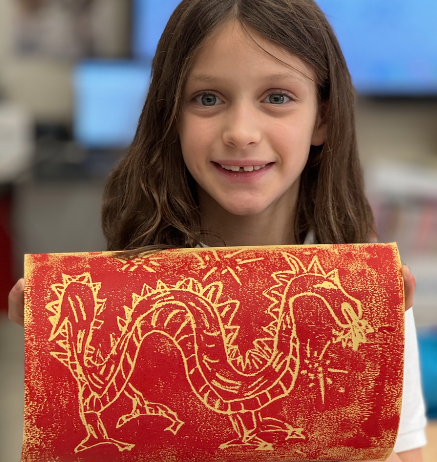 lower school student sculpting clay